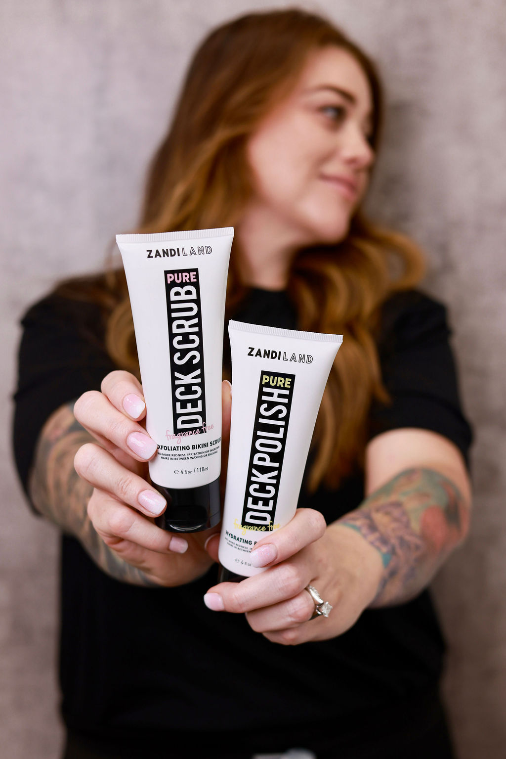 Woman holding two tubes of specialty soap